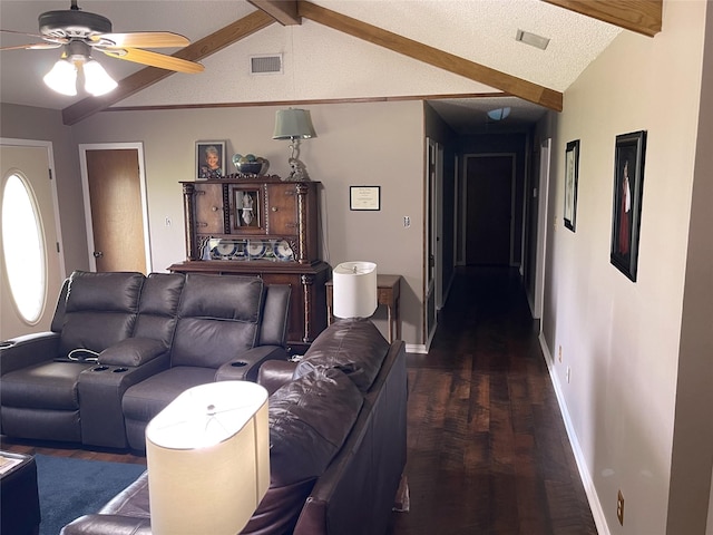 living area featuring lofted ceiling with beams, dark wood-style floors, baseboards, visible vents, and ceiling fan