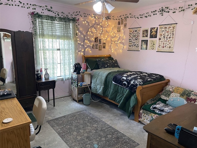 bedroom featuring concrete floors, a ceiling fan, and ornamental molding