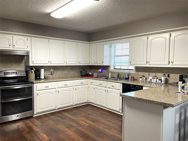 kitchen featuring a peninsula, a sink, double oven range, decorative backsplash, and dark wood-type flooring