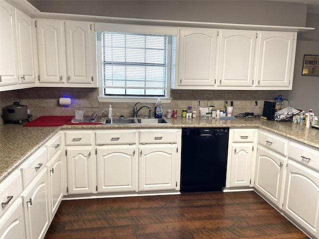 kitchen with dishwasher, backsplash, a sink, and white cabinets