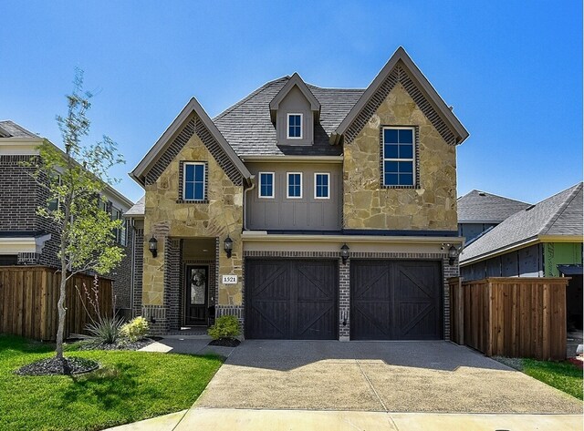 view of front facade featuring fence private yard, brick siding, and a front yard