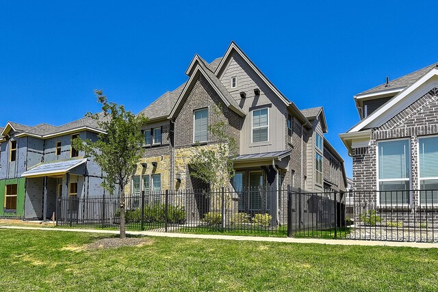 view of front of house featuring a front yard, fence private yard, and stone siding