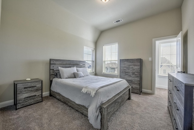 carpeted bedroom featuring visible vents, baseboards, and lofted ceiling