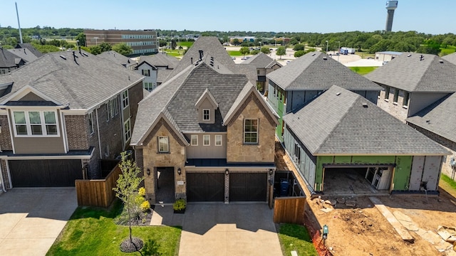 view of front of property with a residential view, a shingled roof, stone siding, a garage, and driveway