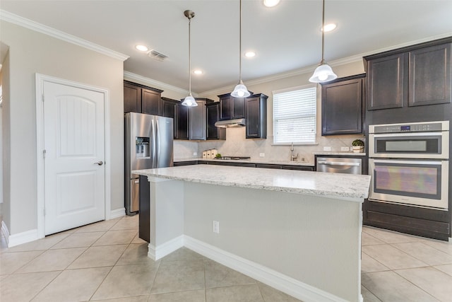 2101 Flagship Ct, Frisco, TX 75036 - kitchen featuring stainless steel appliances, under cabinet range hood, a sink, light tile patterned flooring, and tasteful backsplash