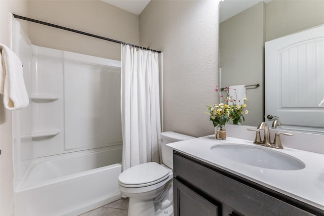 2101 Flagship Ct, Frisco, TX 75036 - bathroom with toilet, vanity, tile patterned flooring, a textured wall, and shower / bath combo with shower curtain