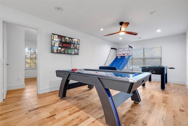 recreation room featuring a ceiling fan, baseboards, and light wood-style flooring