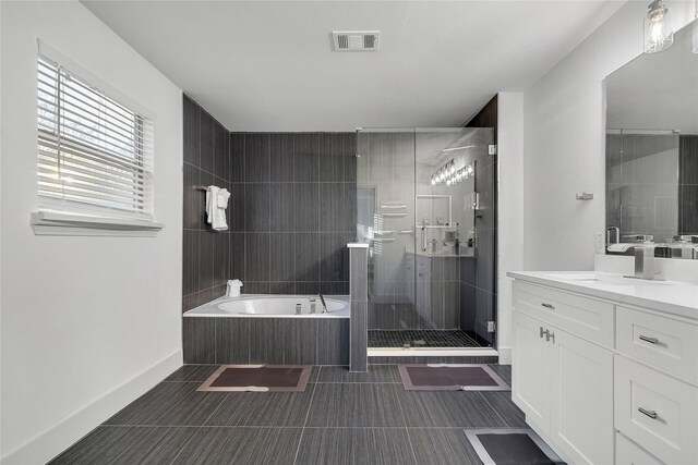 bathroom with a garden tub, visible vents, vanity, and a stall shower