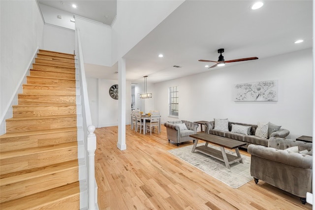 living area featuring recessed lighting, light wood finished floors, stairs, and ceiling fan