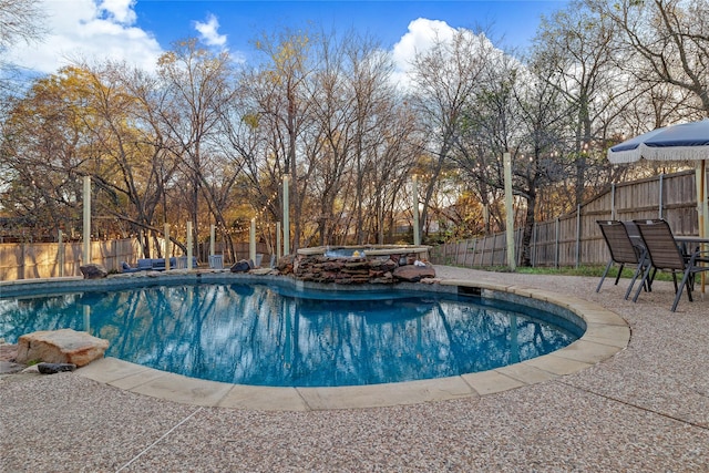view of swimming pool with a fenced in pool, a patio, a fenced backyard, and an in ground hot tub