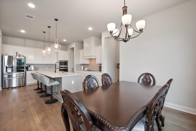 351 Evening Fire Dr, Waxahachie, TX 75167 - dining space featuring a chandelier, baseboards, dark wood-style flooring, visible vents, and recessed lighting