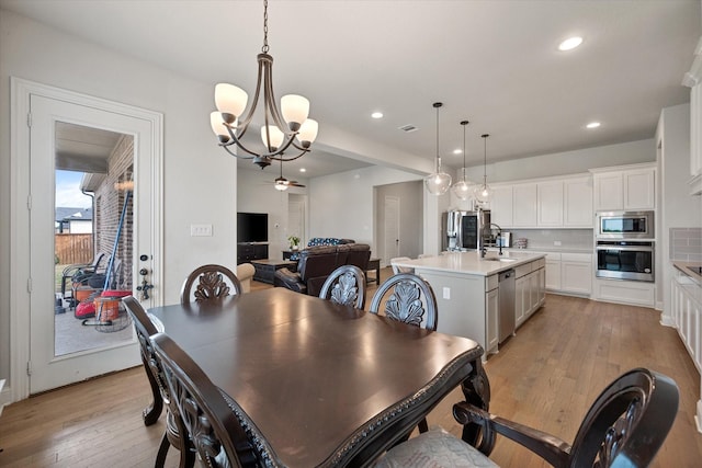 351 Evening Fire Dr, Waxahachie, TX 75167 - dining space featuring recessed lighting, light wood-style floors, visible vents, and ceiling fan with notable chandelier