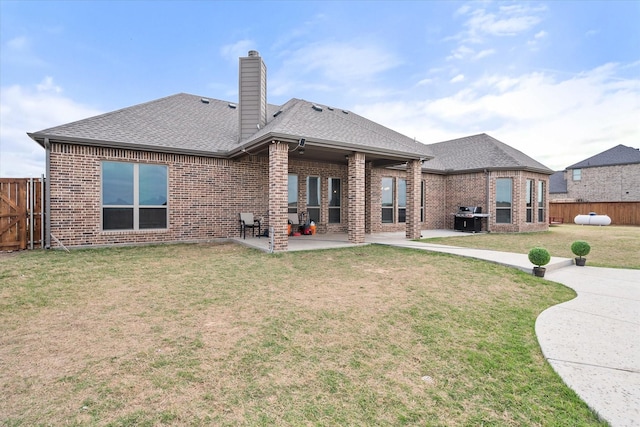 351 Evening Fire Dr, Waxahachie, TX 75167 - back of property featuring brick siding, a patio area, a fenced backyard, a yard, and roof with shingles