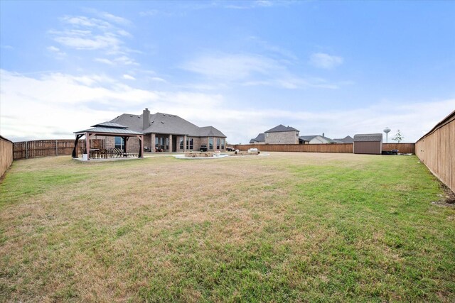 351 Evening Fire Dr, Waxahachie, TX 75167 - view of yard featuring a gazebo, a shed, a fenced backyard, an outbuilding, and a patio