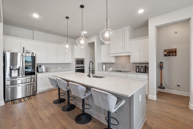 351 Evening Fire Dr, Waxahachie, TX 75167 - kitchen featuring dark wood-style floors, a sink, backsplash, and appliances with stainless steel finishes