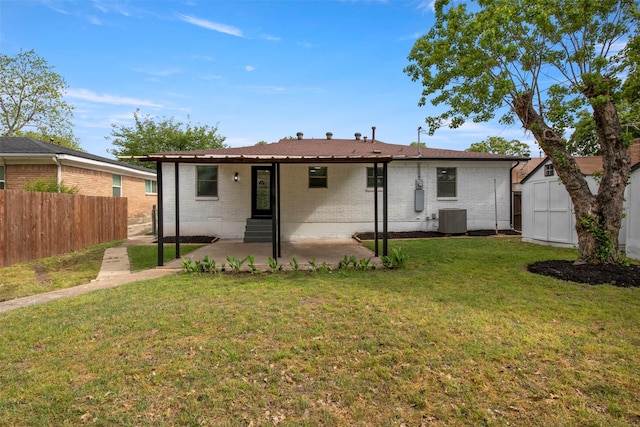 rear view of house featuring central air condition unit, brick siding, fence, and a patio area
