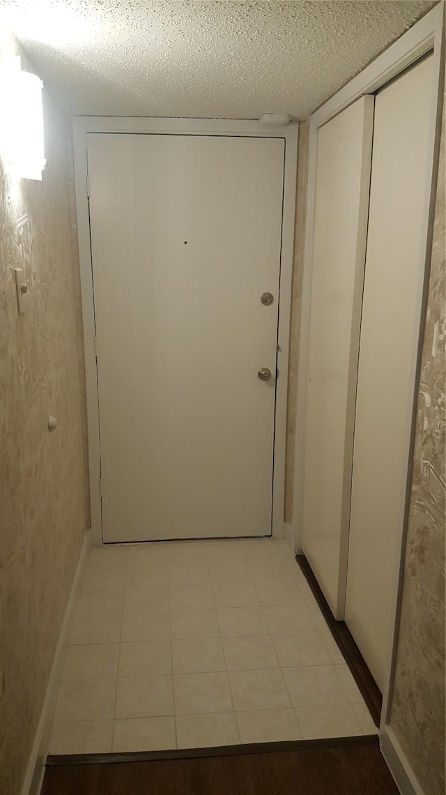 4859 Cedar Springs Rd Unit 358, Dallas, TX 75219 - entryway with a textured ceiling and light tile patterned floors