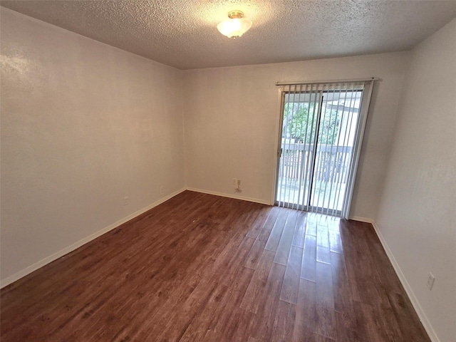 4859 Cedar Springs Rd Unit 358, Dallas, TX 75219 - empty room with dark wood-type flooring, a textured ceiling, and baseboards