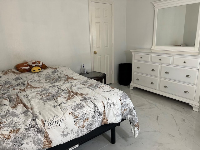 bedroom featuring marble finish floor