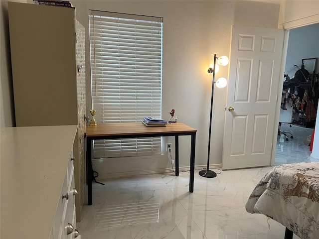 bedroom featuring baseboards and marble finish floor