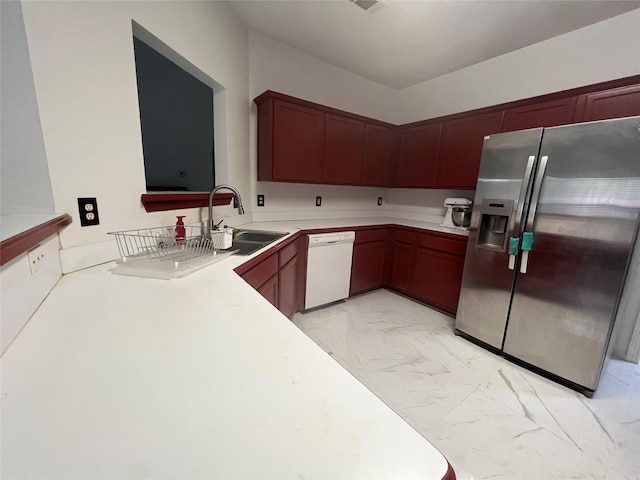 kitchen with marble finish floor, stainless steel refrigerator with ice dispenser, light countertops, a sink, and dishwasher