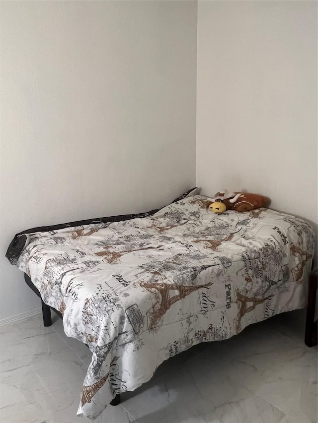 bedroom featuring marble finish floor