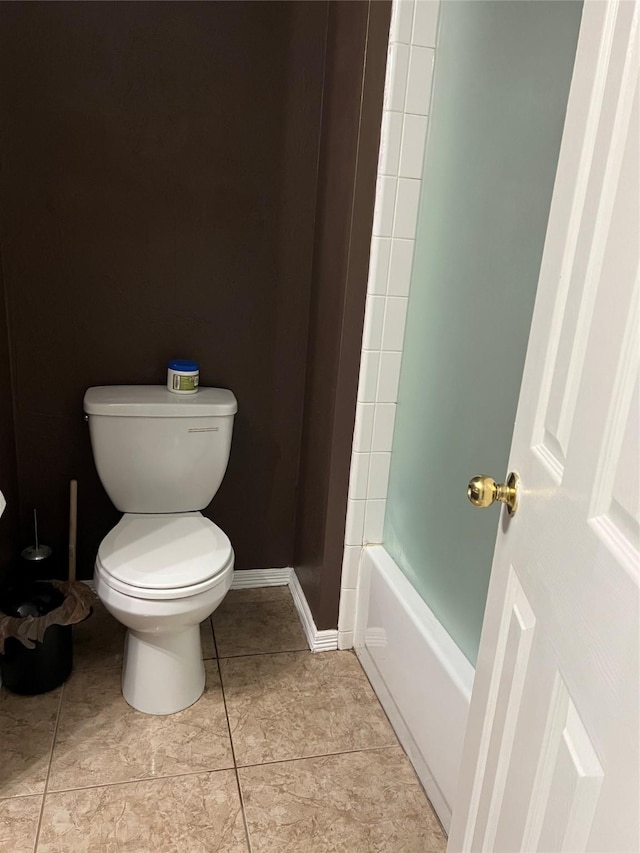 bathroom with baseboards and toilet