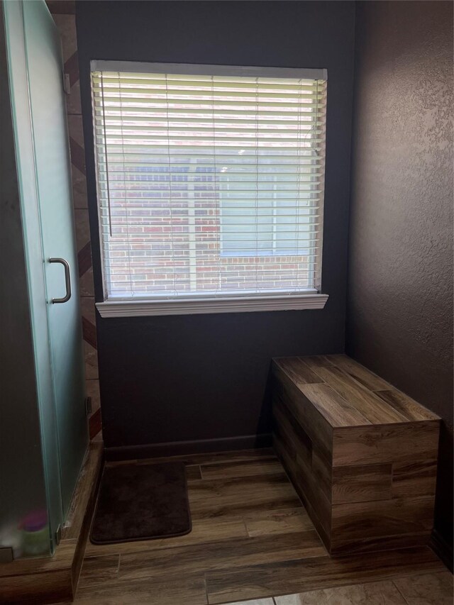 bathroom featuring double vanity, a sink, and a textured wall
