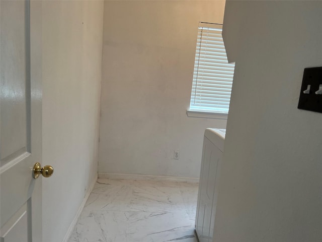 laundry room with laundry area, baseboards, and marble finish floor