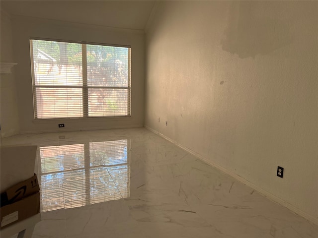 empty room featuring baseboards and marble finish floor