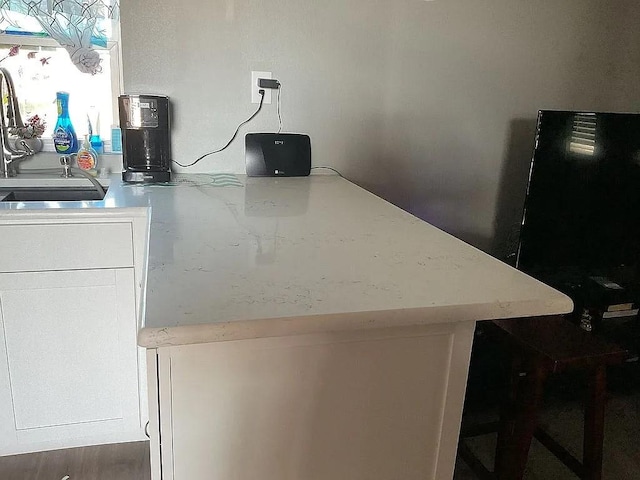interior space with white cabinets and a sink