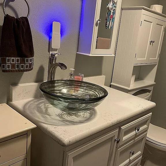 half bath featuring vanity and toilet