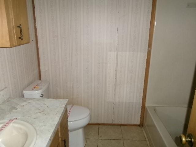 full bathroom featuring tile patterned floors, toilet, a bathing tub, walk in shower, and vanity