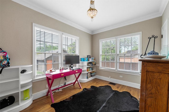 office space featuring a chandelier, wood finished floors, visible vents, and crown molding