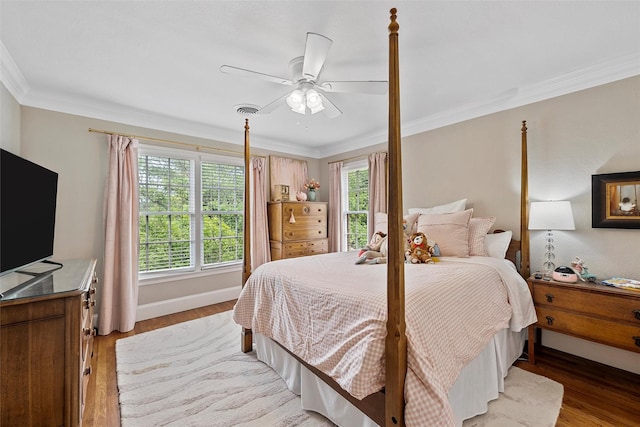 bedroom with multiple windows, light wood-type flooring, and ornamental molding