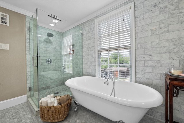 full bath with tile walls, a freestanding tub, a stall shower, and visible vents