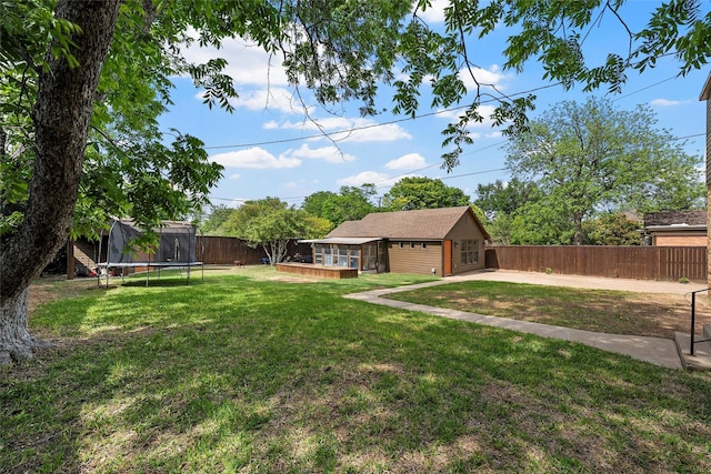 view of yard featuring a fenced backyard and a trampoline