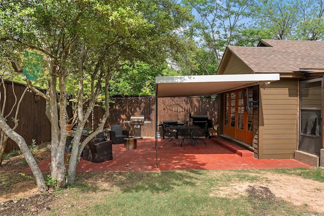 view of yard featuring fence, a patio area, and french doors
