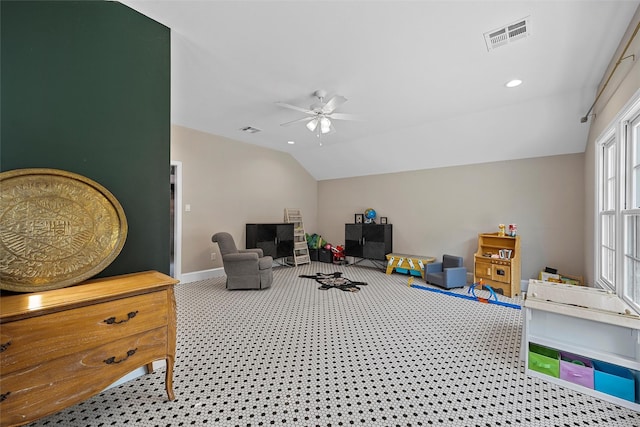 recreation room featuring vaulted ceiling, a ceiling fan, baseboards, carpet flooring, and visible vents