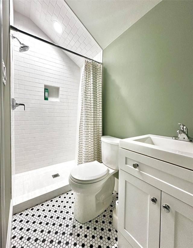 full bath featuring lofted ceiling, a shower stall, toilet, and vanity