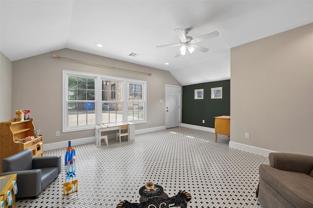 interior space with vaulted ceiling, visible vents, baseboards, light colored carpet, and a ceiling fan