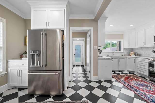 kitchen with tile patterned floors, stainless steel appliances, white cabinetry, and light countertops