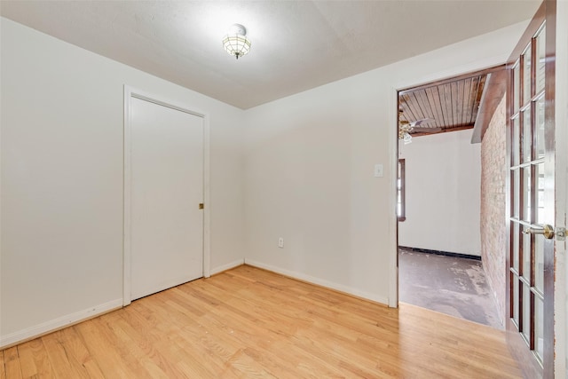 interior space with baseboards and wood finished floors