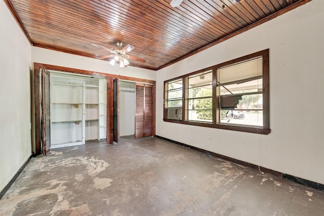 unfurnished bedroom with wood ceiling, a ceiling fan, baseboards, and concrete floors