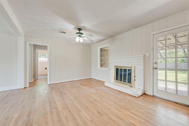 unfurnished living room with wood finished floors, visible vents, ornamental molding, baseboards, and ceiling fan