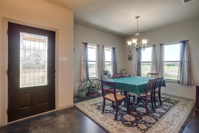 dining space with baseboards, a notable chandelier, and concrete flooring