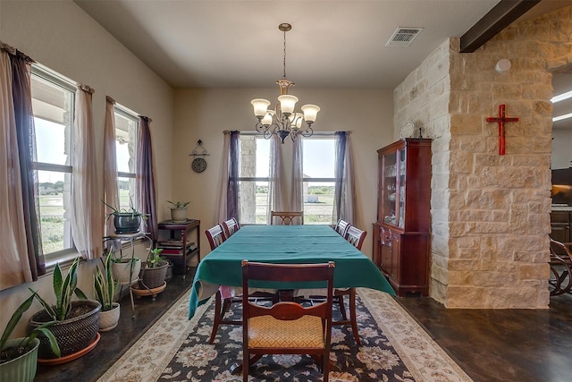 dining area with plenty of natural light, wood finished floors, visible vents, and a chandelier