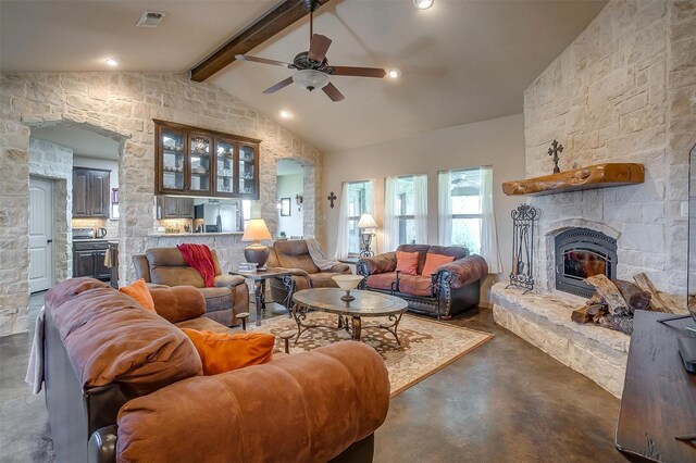 living area featuring visible vents, lofted ceiling with beams, a fireplace, finished concrete flooring, and ceiling fan