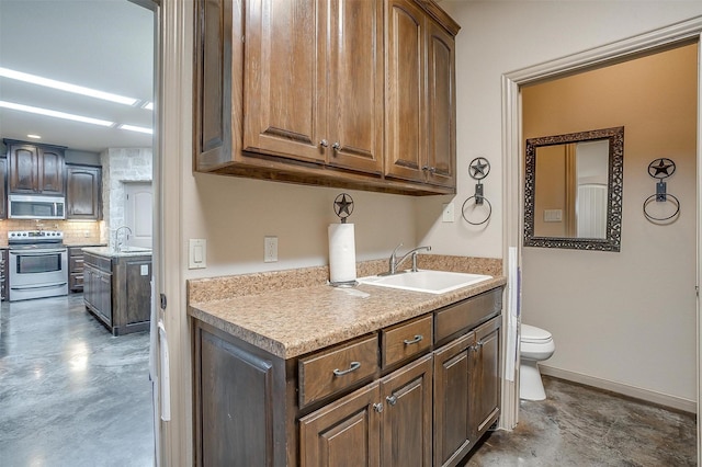 bathroom featuring backsplash, toilet, and vanity