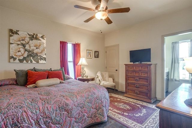 bedroom featuring ensuite bathroom and ceiling fan